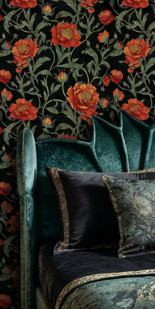 Dark floral wallpaper with coral peonies and flowing vines, shown in living room with teal velvet armchair
