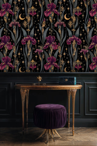 Dark floral wallpaper with iris blooms and celestial elements shown in sophisticated study with antique desk