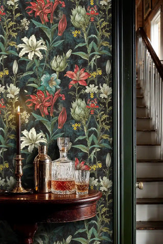 Dark floral wallpaper with lilies and botanical elements in sophisticated entryway with brass decanter