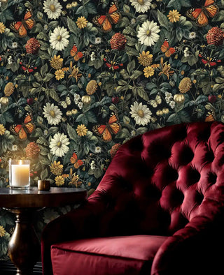 Dark floral wallpaper with orange butterflies and cream flowers in elegant living room with red velvet chair