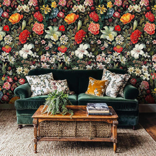 Dark floral wallpaper with peonies and lilies shown in sophisticated living room with emerald velvet sofa
