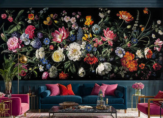 Dark floral wallpaper with pink peonies and blue flowers in modern living room with navy blue sofa and brass accents