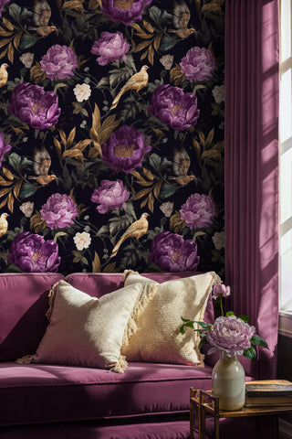 Dark floral wallpaper with purple blooms and golden birds on navy background, displayed in elegant living room
