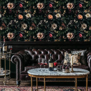 Dark floral wallpaper with songbirds and blooms in classic gentleman's lounge with chesterfield sofa