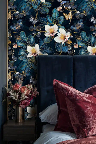 dark floral wallpaper with white hibiscus blooms in sophisticated bedroom with velvet headboard