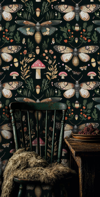 Dark moth and mushroom wallpaper with golden wings and toadstools, shown with a rustic green chair