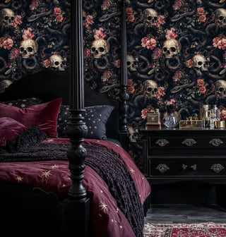 Dark romantic wallpaper with skulls and florals in elegant bedroom with burgundy velvet bedding