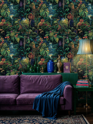 Dark tropical rainforest wallpaper with lush palms and waterfalls, shown in a living room with purple velvet sofa