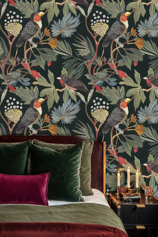 Dark tropical wallpaper featuring exotic birds and botanical elements displayed in elegant bedroom with velvet pillows