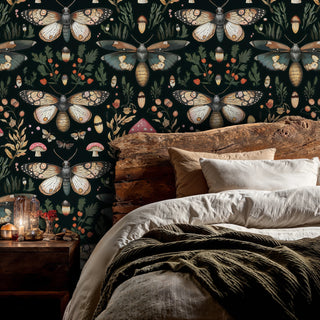 Dark woodland moth wallpaper with toadstool details, behind a rustic raw-wood headboard with candles