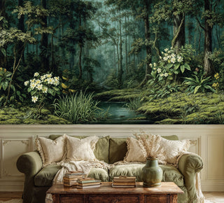 Deep green forest wall mural with wildflowers and creek in an elegant room with olive linen sofa and books