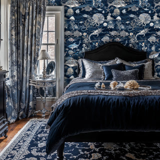 Deep ocean marine wallpaper featuring detailed sea creatures and nautical motifs, shown in elegant bedroom with ornate bed