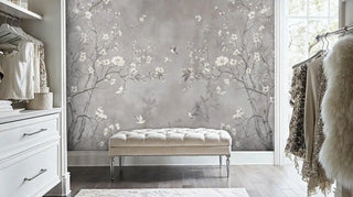Delicate botanical wall mural with hummingbirds and cherry blossoms, shown in bright bedroom with tufted bench