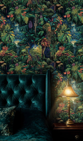 Dense jungle wallpaper with exotic blooms and trailing vines, displayed in a bedroom with teal velvet headboard
