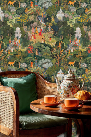 Detailed Indian garden wallpaper featuring ornate temples and wildlife, shown in an elegant sitting room with wicker chairs and teapot