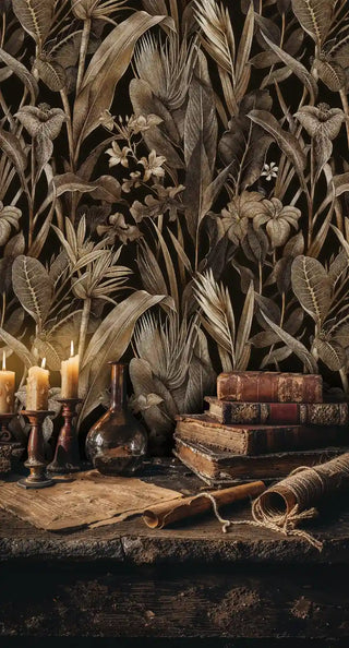 Detailed lily and palm wallpaper in golden tones, displayed in study corner with vintage books and candles