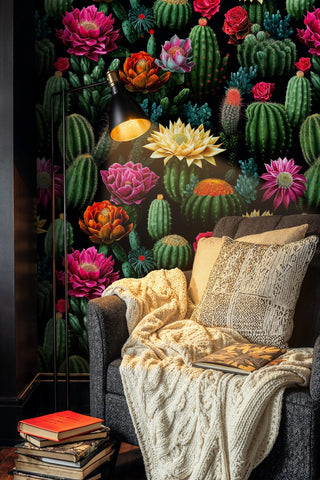 Detailed view of a cactus bloom wallpaper, green and black, shown with floor lamp and books