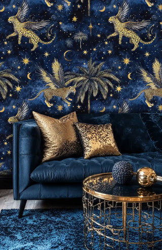 Detailed view of a celestial wallpaper with winged leopards, with navy sofa and gold pillows