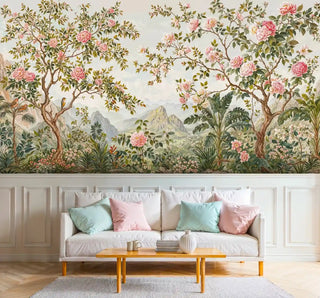 Detailed view of a chinoiserie Wall Mural featuring pink blooms, birds, green; pale sofa, pastels
