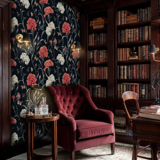 Detailed view of a dark floral wallpaper; carnations; black-red; library scene with burgundy armchair and decanter