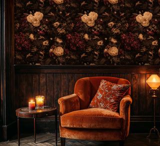 Detailed view of a floral hummingbird Wallpaper with layered blooms and birds in a moody nook with velvet armchair and candle