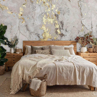 Detailed view of a gilded marble wall mural, grey and gold, in bedroom with wood headboard