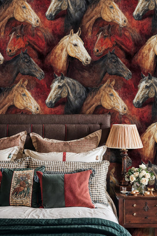 Detailed view of a Horse Wallpaper with layered horse portraits in red, brown and cream, with a bedside lamp