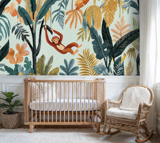Detailed view of a jungle monkey wall mural with teal and mustard leaves, nursery crib