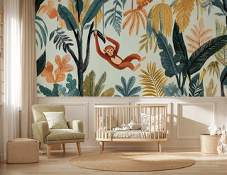 Detailed view of a jungle monkey wall mural with teal leaves, sage armchair and jute rug