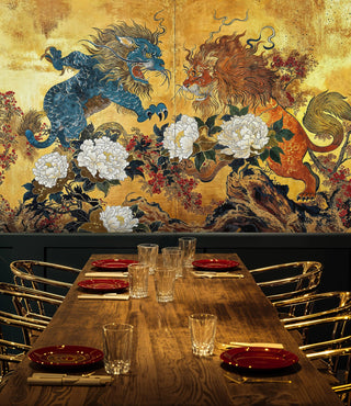 Detailed view of a lions and peonies wall mural, gold and blue, with gold chairs.