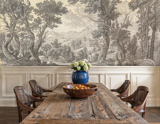 Detailed view of a pastoral landscape Wall Mural in beige and grey, etched trees and hills, shown with a rustic farm table and blue vase