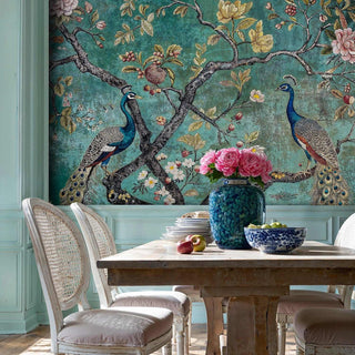 Detailed view of a peacock wall mural in teal and gold, with peony bouquet in blue vase