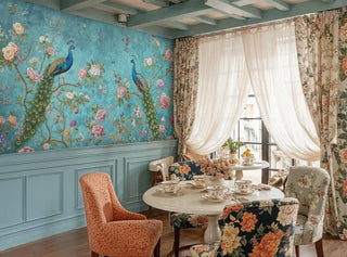 Detailed view of a peacock wall mural, teal and green florals, shown with round table and curtains