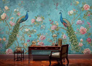 Detailed view of a peacock wall mural with florals, teal and green, shown with brass lamp on desk