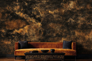 Detailed view of an abstract texture Wall Mural in black and brown, shown behind a rust velvet sofa and carved table.
