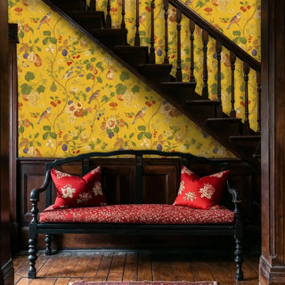Detailed view of an Orchard Birds Wallpaper on mustard yellow with vines, by staircase bench