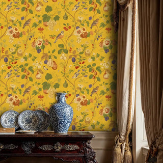 Detailed view of an Orchard Birds Wallpaper with birds and fruit on yellow, with blue vase