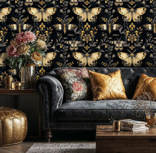 Detailed view of black-gold moth wallpaper, shown with a gold pouf