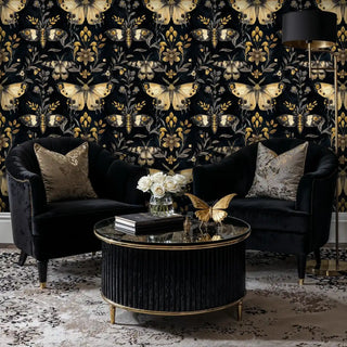 Detailed view of black-gold moth wallpaper, shown with a round glass table