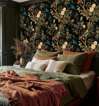 Detailed view of chinoiserie wallpaper, black and green, behind a bed with layered linens