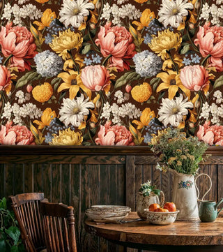 Detailed view of dark floral Wallpaper with lush blooms, with a vintage pitcher and apples