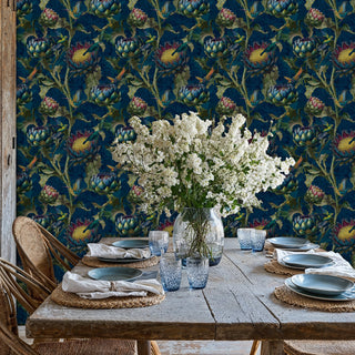 Detailed view of hummingbird wallpaper in navy and green, with white flowers in a glass vase