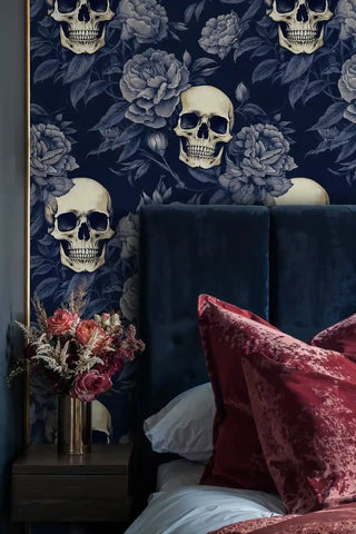 Detailed view of skull floral wallpaper, navy and ivory, with red velvet pillows