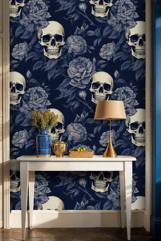 Detailed view of skull peony wallpaper, navy and ivory, with brass table lamp