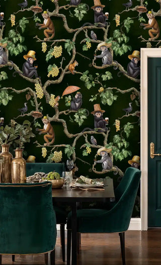 Detailed view of vineyard monkey wallpaper, deep green and gold vines, by velvet chairs