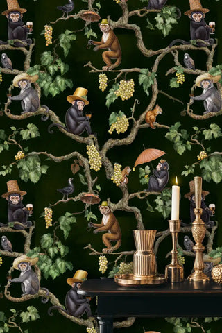 Detailed view of vineyard monkey wallpaper with deep green and gold vines with brass candles