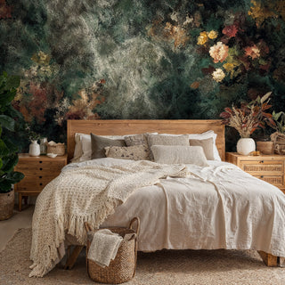 Distressed floral abstract wallpaper in earth tones shown in cozy bedroom with wooden bed and neutral linens