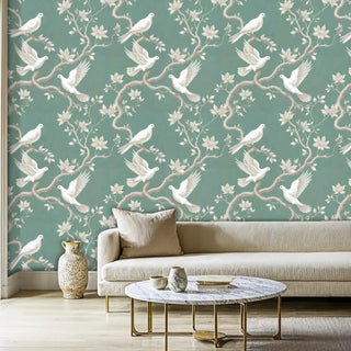 Dove and magnolia wallpaper featuring white birds on branches, displayed in living room with marble coffee table