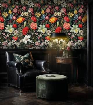 Dramatic botanical wallpaper featuring colorful blooms in moody study with black leather armchair and fireplace