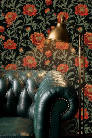 Dramatic botanical wallpaper with orange peonies, displayed in study with green leather chesterfield sofa
